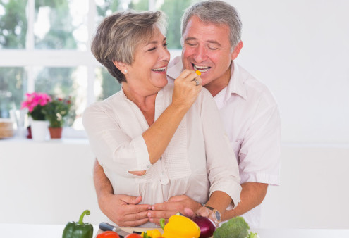 Mature couple eating in kitchen