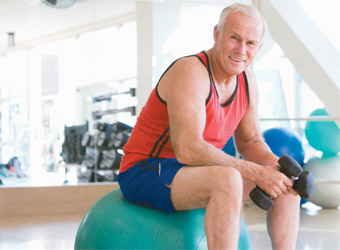 Senior man with weights at gym