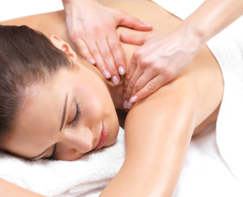 Close-up of a young woman receiving back massage at spa