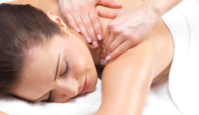 Close-up of a young woman receiving back massage at spa