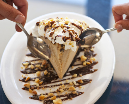 Two people sharing chocolate dessert