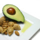 Avocado, nuts and olive oil on plate