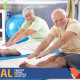 Older man and woman stretching in gym