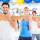 Man stretching at front of gym class