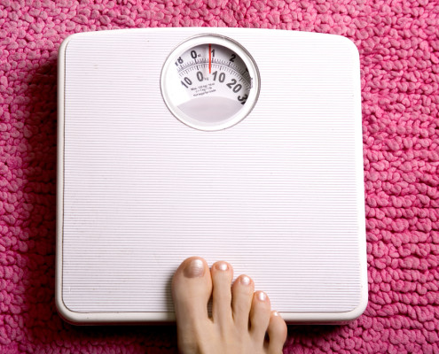 Woman's foot stepping on scales