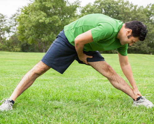 Man stretching in park