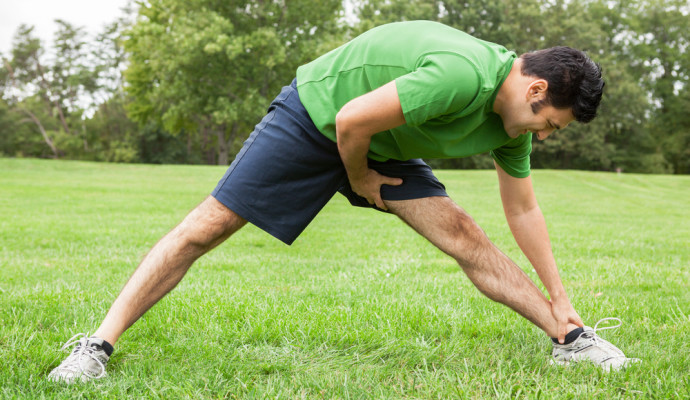 Man stretching in park