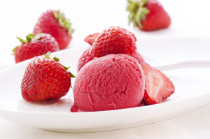 Strawberry sorbet with strawberries on white plate