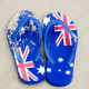 Thongs with Australian flag pattern on sand at beach