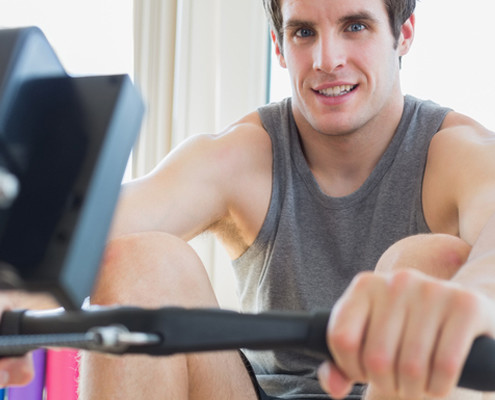 Man on rowing machine in gym