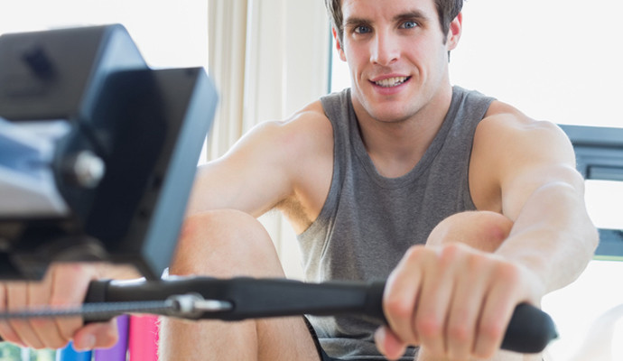 Man on rowing machine in gym