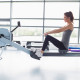 Woman on rowing machine in front of window