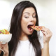 Woman eating pizza instead of salad