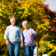 Older couple walking through park