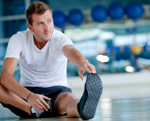 Man stretching in gym