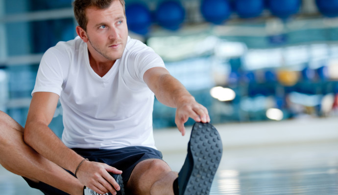 Man stretching in gym