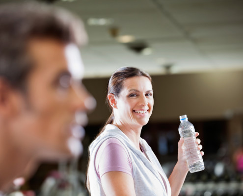 Woman smiling with water bottle