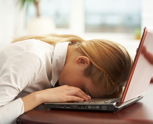 woman asleep at laptop